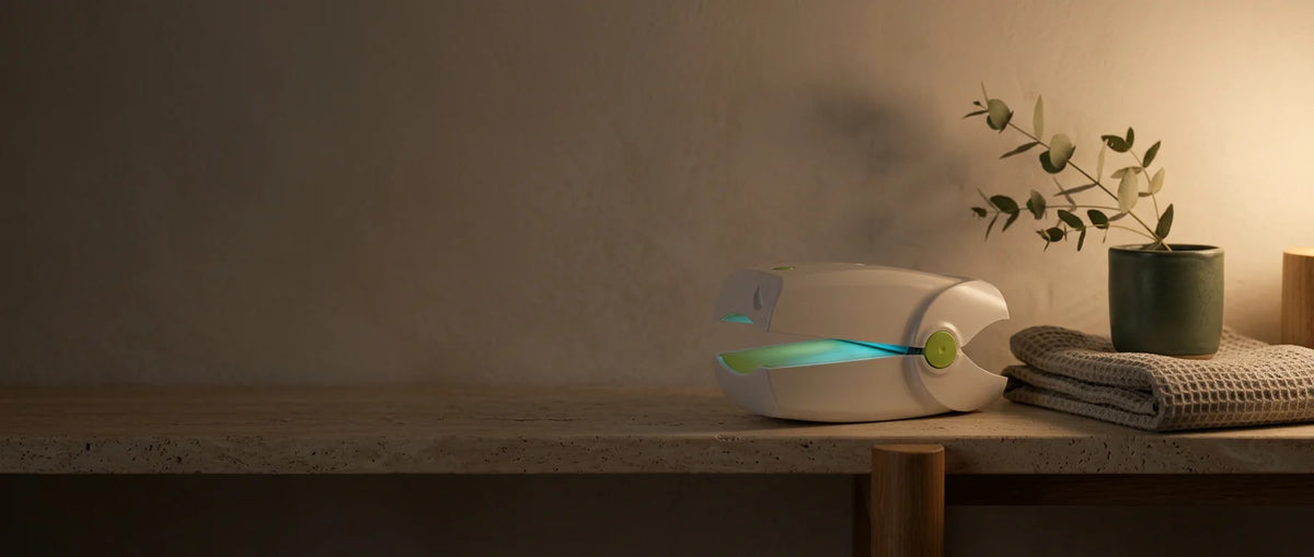 The device on a bathroom shelf in the evening